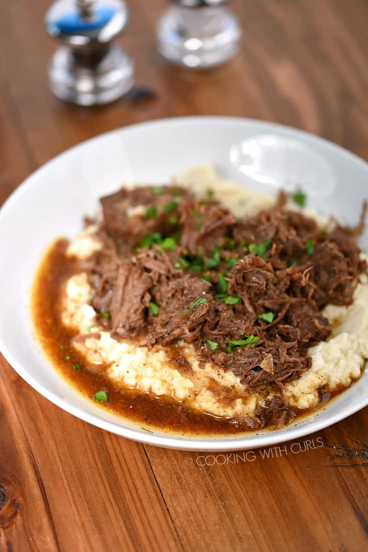 A big bowl of Instant Pot Cafe Mocha Pot Roast served over fluffy mashed cauliflower.