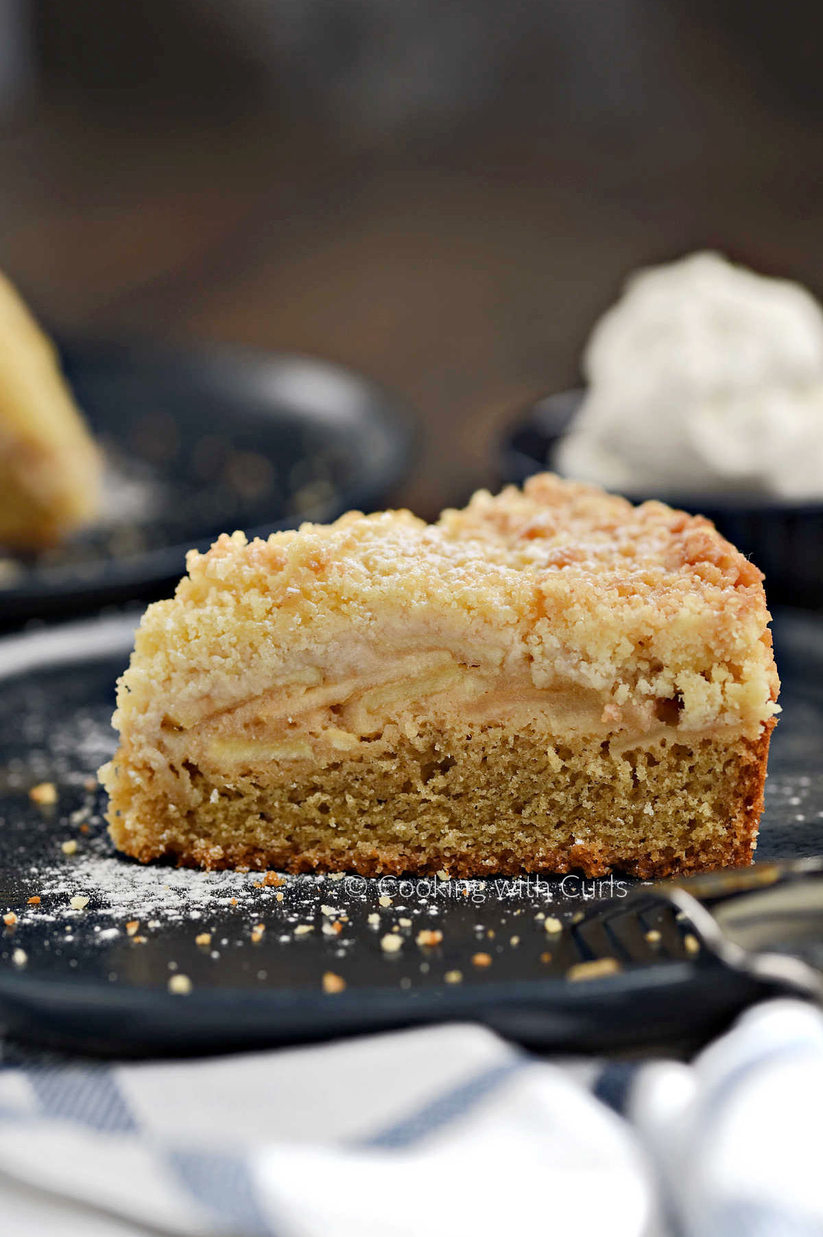 A slice of Irish Apple Cake on a blue plate. 