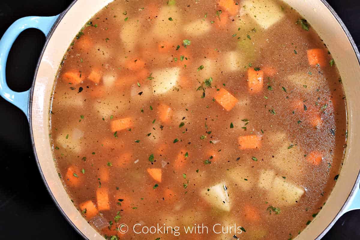 Chopped-vegetables-stock-herbs-in-Dutch-oven.