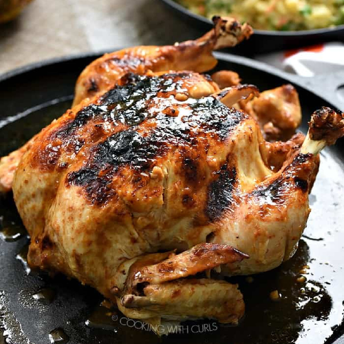 Whole Huli Huli Chicken on a black skillet.