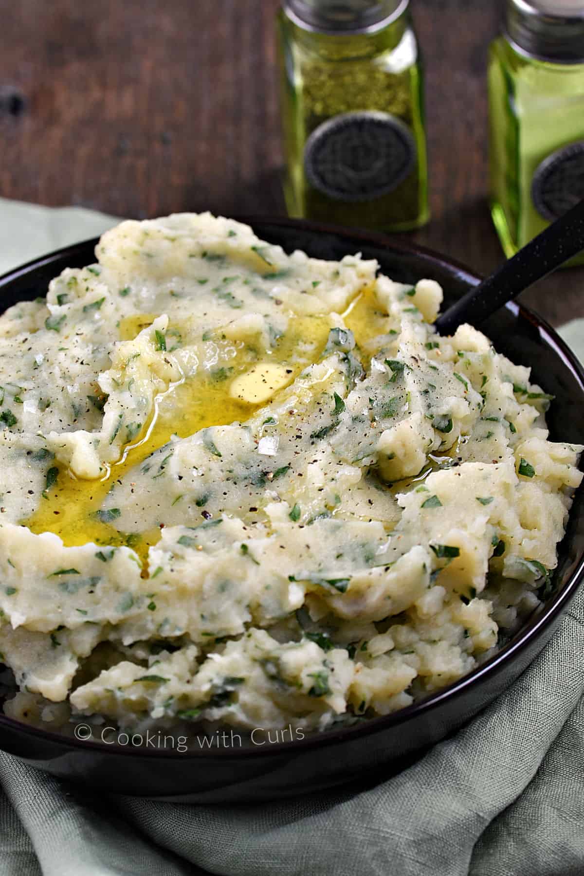 Instant Pot Irish Champ Potatoes topped with a knob of butter in a large bowl. 