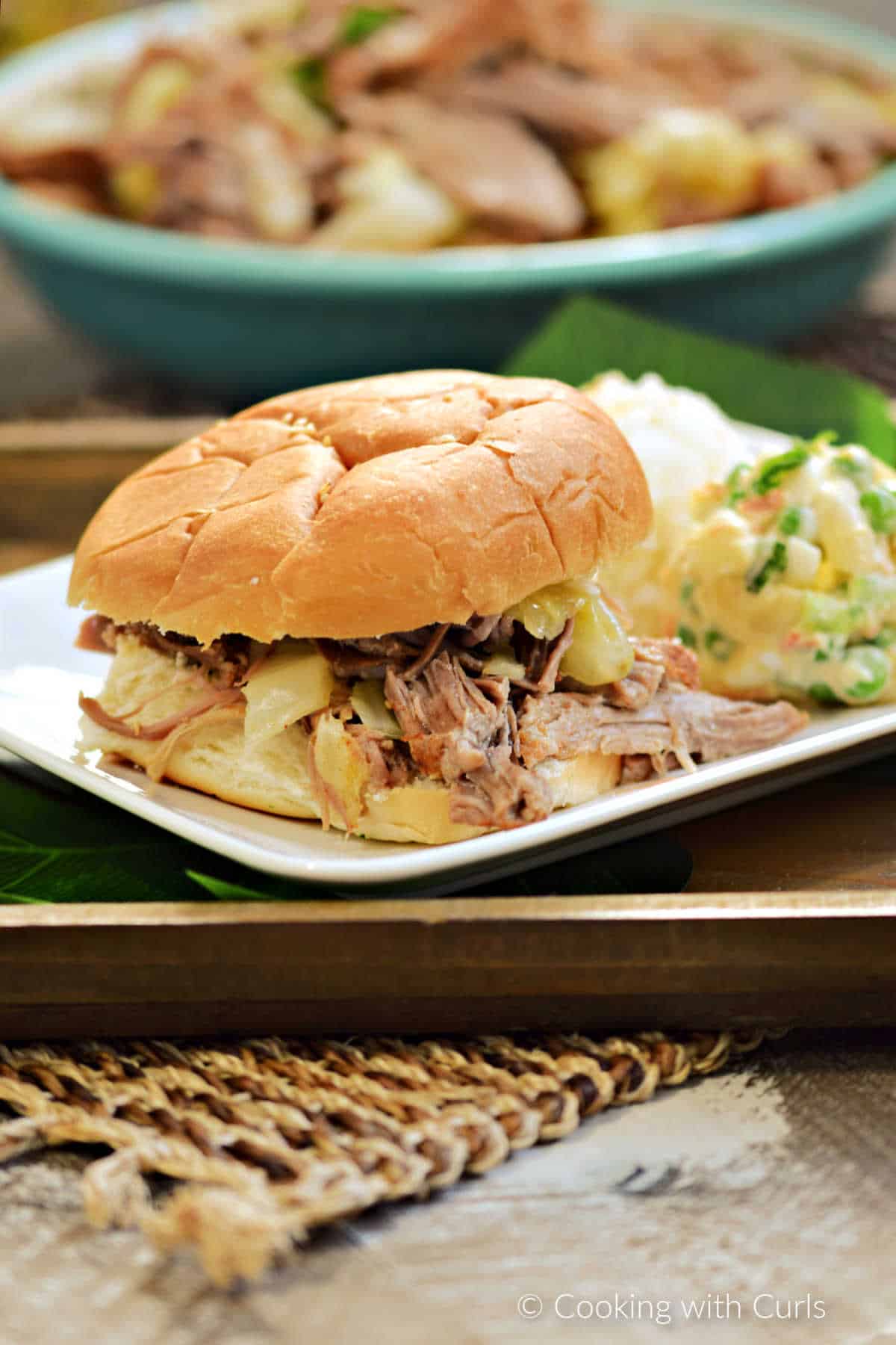 Instant Pot shredded Kalua pork sandwich with rice and Hawaiian potato mac salad on the side.