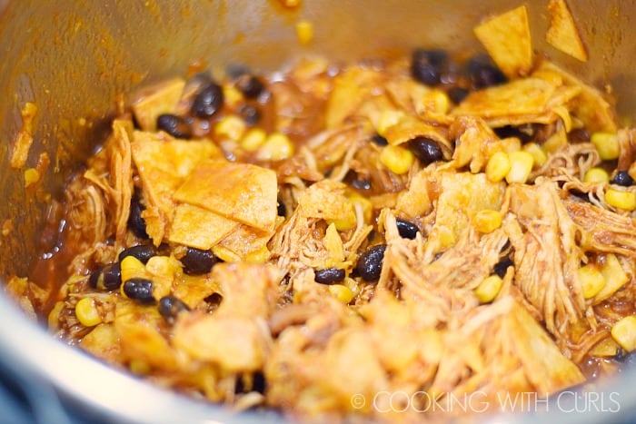 Instant Pot Mexican Casserole mix in the tortillas beans corn and cheese.