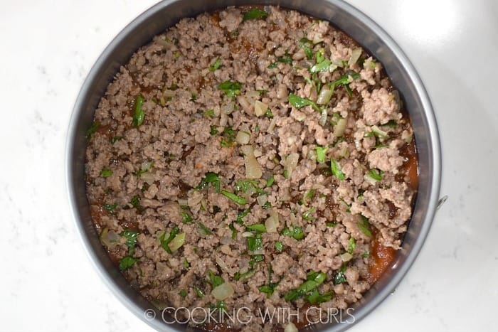 Layer the sauce and meat mixture over the noodles