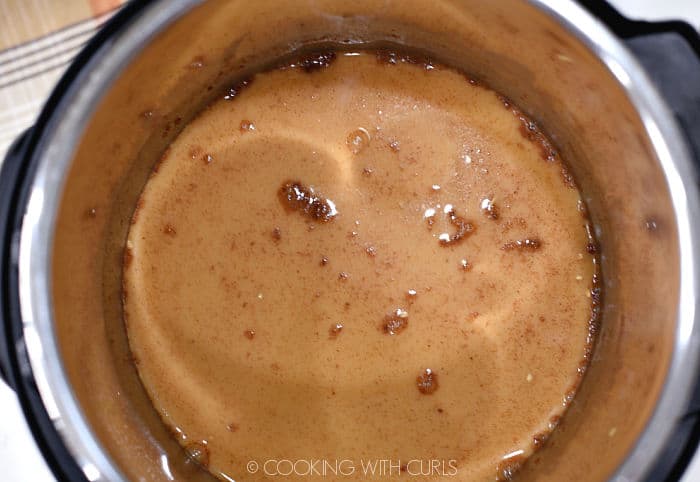 Looking down on milk, pumpkin and spices in an Instant Pot. 