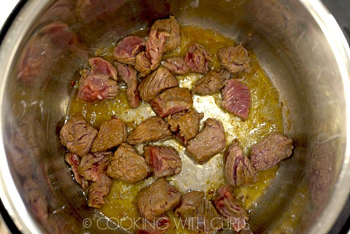 Sautéed beef chunks in the bottom of the instant pot liner. 