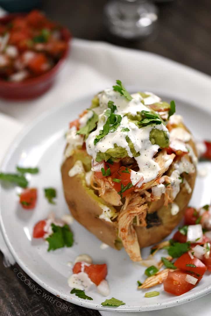 These Taco Chicken Stuffed Sweet Potatoes have layer upon layer of flavor. They are sure to become a family favorite! cookingwithcurls.com