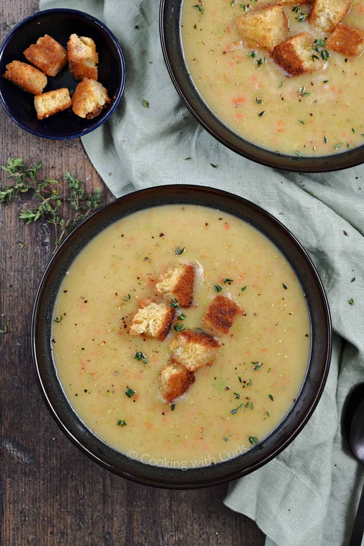 Looking down on two bowls of Irish Vegetable Soup topped with sourdough croutons.