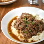 Instant Pot Cafe Mocha Pot Roast titled image served over mashed cauliflower.